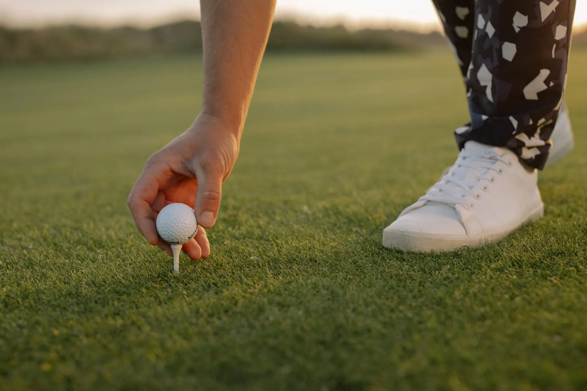 Golfer Teeing Up A Golf Ball